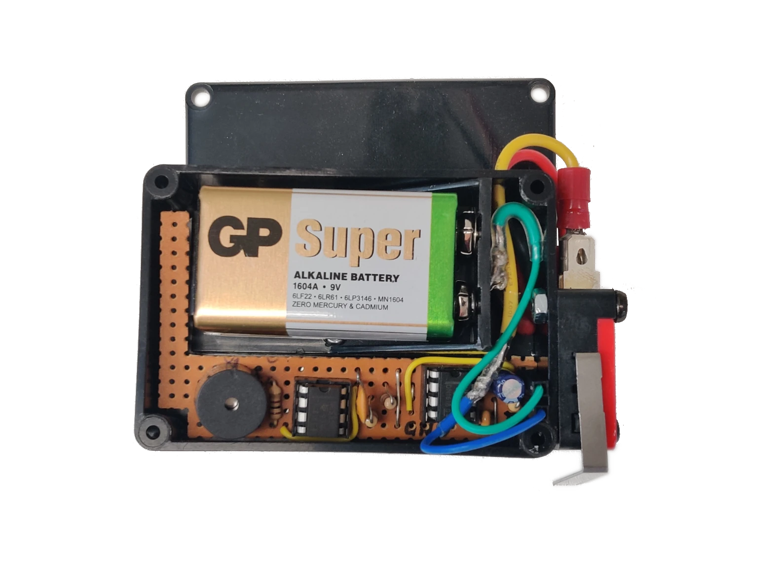 View inside the box. Buzzer on the left with the oscillator next to it. The time delay circuit on the right.